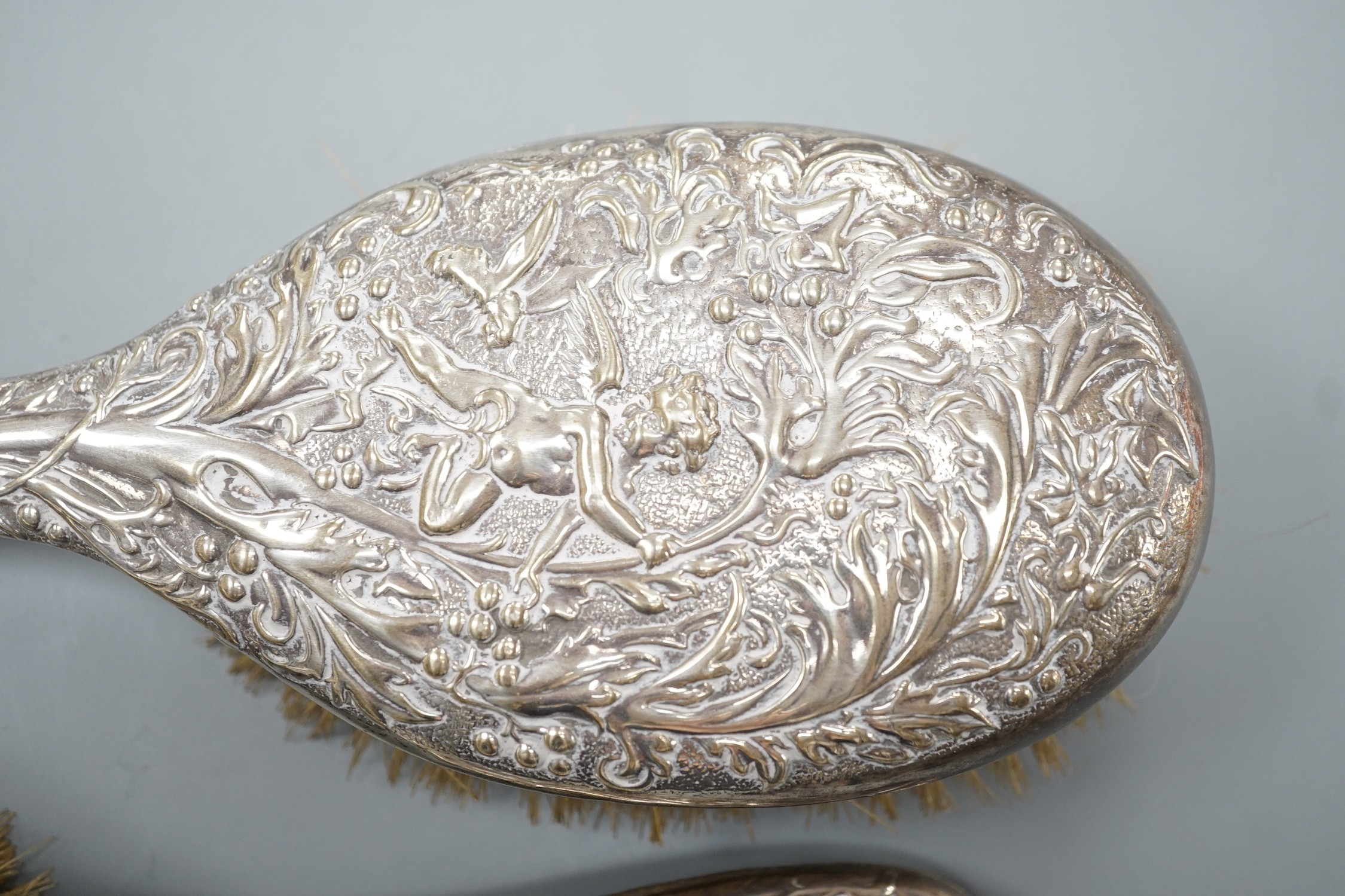 A pair of late Victorian repousse silver mounted hairbrushes, Birmingham, 1893.
